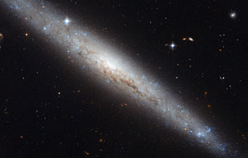 Hubble portrays a dusty spiral galaxy