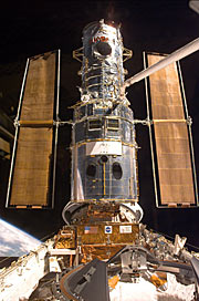 Hubble has just been "grappled" by ESA astronaut Jean-François Clervoy. It is now being put on the "berthing platform" which has been specially constructed to accommodate the telescope during the repairs.